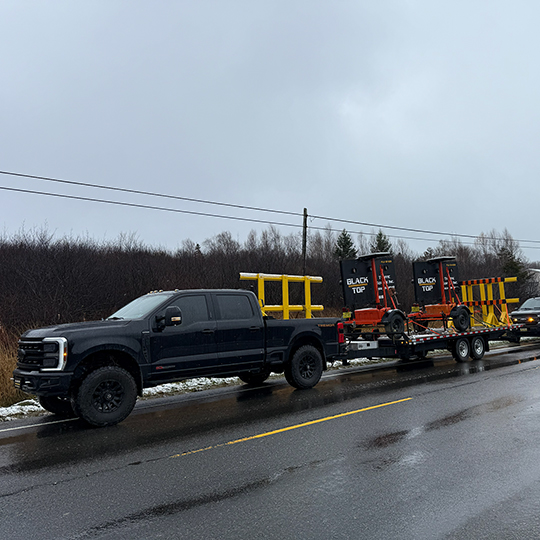 Blacktop Traffic Service truck hauling message boards