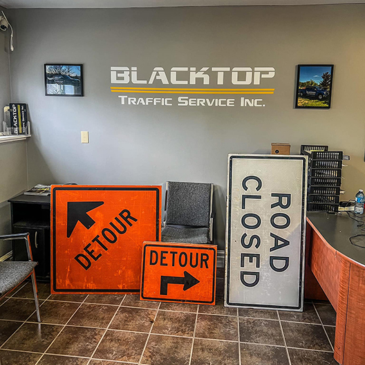 Blacktop Traffic Service office with detour and road closed signs